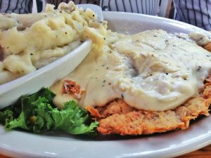 Chicken fried steak and mashed potatoes covered in white peppered gravy